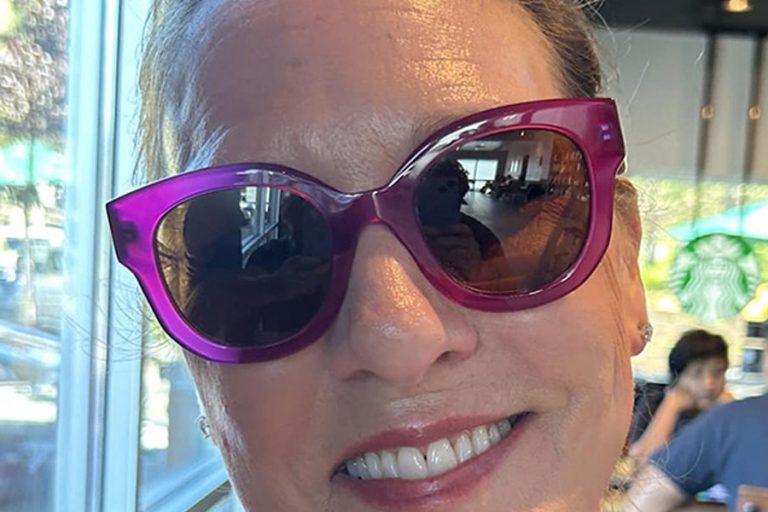 Woman wearing pink framed sunglasses